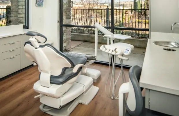 A treatment chair at Golden Hills Family Dental, beside a window.