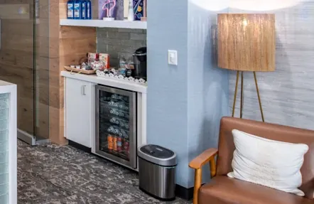 Shelves, a coffee bar and a drinks fridge beside the reception desk.
